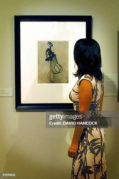 Woman examines the print "La Femme" which was made by surrealist photographer Man Ray in 1920 and is part of an exhibition of his work which opened...