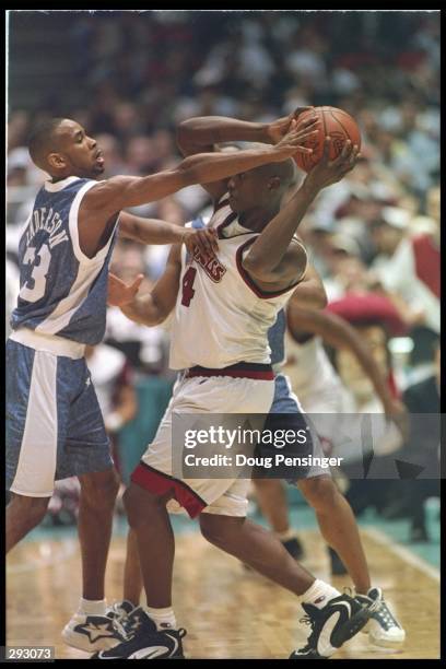 Forward Donta Bright of the Massachusetts Minutemen tries to fend off guard Derek Anderson of the Kentucky Wildcats during a playoff game at the...