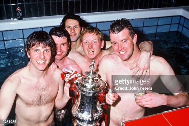 Lee Sharpe, Denis Irwin, Ryan Giggs, David May and Gary Pallister of Manchester United celebrate in the dressing room with the FA Cup after the...