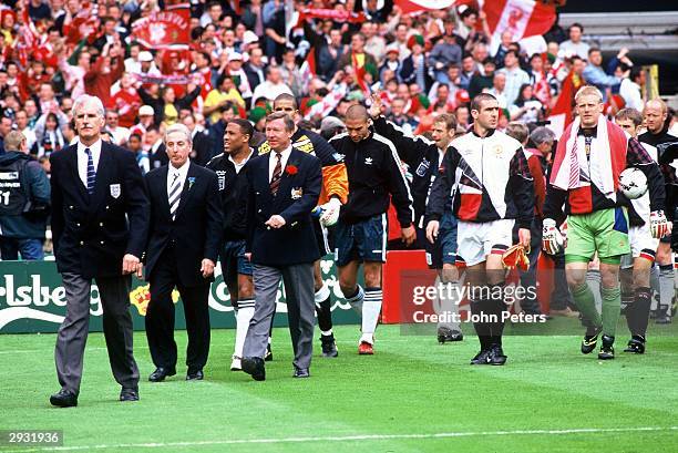 Sir Alex Ferguson and Roy Evans of Manchester United lead the teams out before the Liverpool v Manchester United FA Cup Final between Liverpool v...