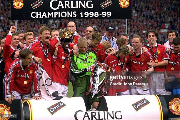 The Manchester United team celebrate on the pitch having been presented with the trophy after the FA Carling Premiership match between Manchester...