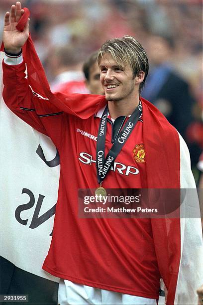 David Beckham celebrates having received his Premiership Winners medal after the FA Carling Premiership match between Manchester United v Tottenham...