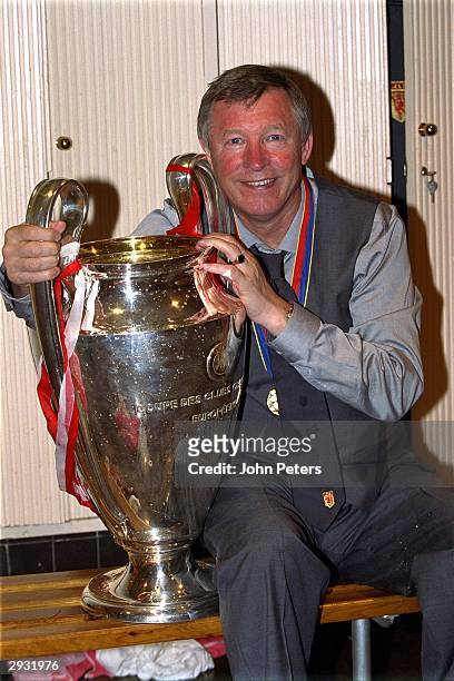 Sir Alex Ferguson celebrates with the European Cup in the dressing room after the UEFA Champions League Final between Bayern Munich v Manchester...