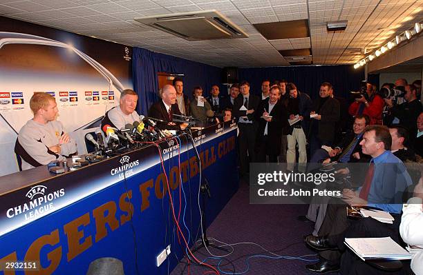 Sir Alex Ferguson and Paul Scholes attend a press conference prior to the Manchester United training session prior to the UEFA Champions League match...