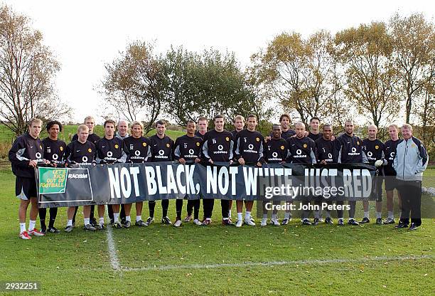 The Manchester United squad hold up a banner supporting the 2003 drive to kick racism out of football during a Manchester United training session at...