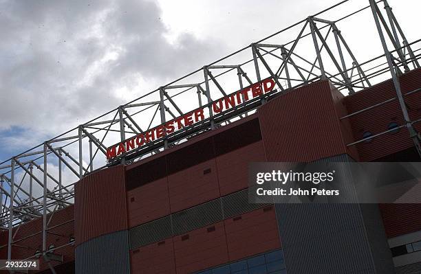 General view of the neon Manchester United sign on top of the North Stand at Old Trafford in silhouette on October 4, 2003 in Manchester, England.