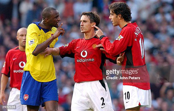 Gary Neville holds Patrick Vieira and Ruud van Nistelrooy apart prior to Vieira being sent off during the FA Barclaycard Premiership match between...