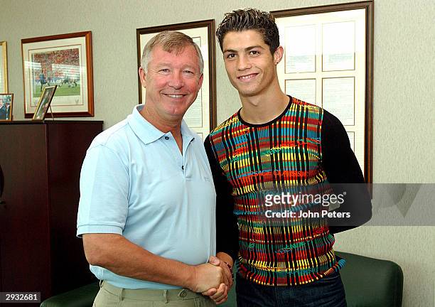 Sir Alex Ferguson greets Cristiano Ronaldo as the young Portugese player signs for Manchester united at the Carrington Training Ground, Carrington on...