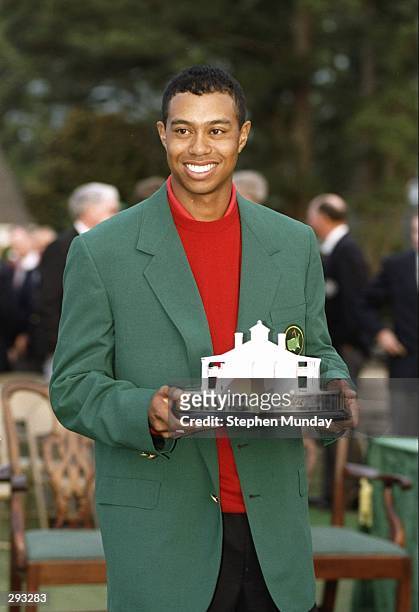 Tigers Woods wears his green jacket and holds his trophy at the Masters Tournament at the Augusta National Golf Course in Augusta, Georgia. Mandatory...