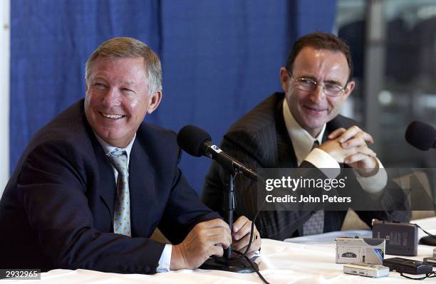 Sir Alex Ferguson and Celtic manager Martin O'Neill share a laugh with reporters at their press conference ahead of the friendly match in Seattle...