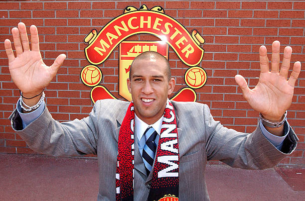 Tim Howard poses for press photographers after signing his contract at Old Trafford on July 15, 2003 in Manchester, England.