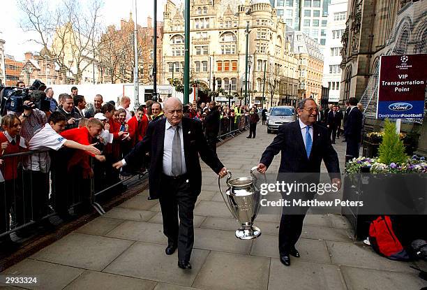 Alfredo Di Stefano and Francisco Gento carry the UEFA Champions League Trophy into the Town Hall during the UEFA Champions League Trophy Handover,...