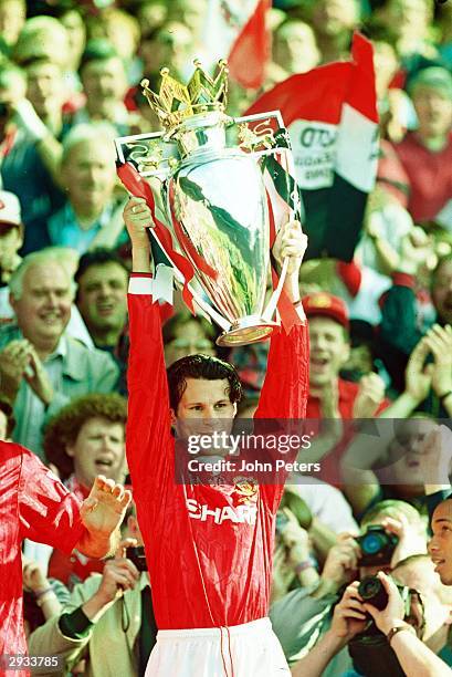 Ryan Giggs of Manchester United lifts the Premiership Trophy after the club becomes FA Carling Premiership Winners in the 1993-94 season at Old...