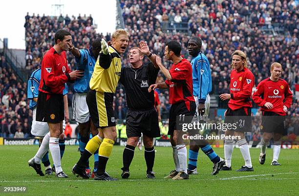 Ryan Giggs talks to the referee while Peter Schmeichel argues against the free kick given for a foul on Ruud Van Nistelrooy during the FA Barclaycard...