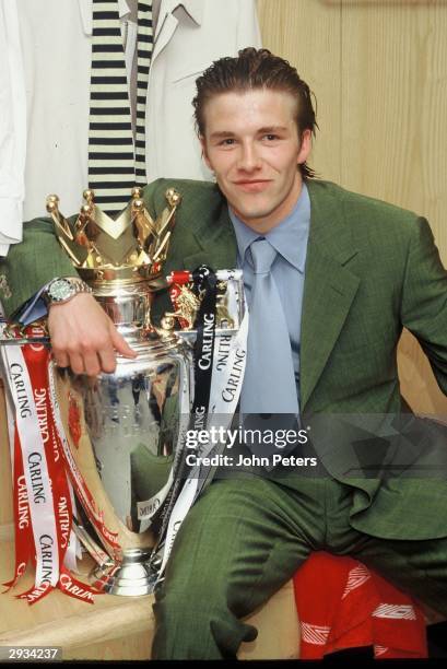 David Beckham of Manchester United celebrate in the dressing room with the FA Carling Premiership trophy after the match between West Ham United v...
