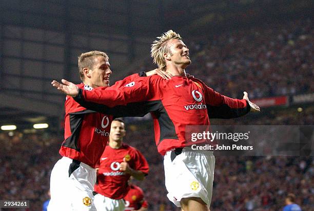 David Beckham celebrates with Phil Neville and Ryan Giggs after scoring during the UEFA Champions League Qualifier match between Manchester United v...