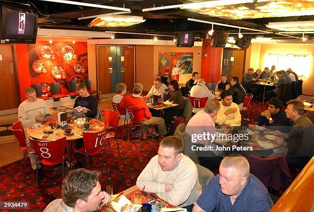 Manchester United fans enjoy a pre-match meal at Old Trafford.