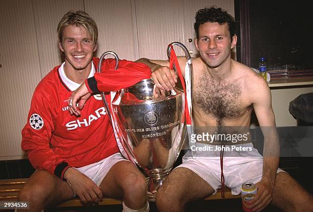 David Beckham and Ryan Giggs celebrate with the European Cup in the dressing room after the UEFA Champions League Final between Bayern Munich v...