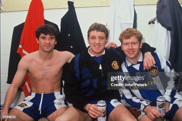 Roy Keane, Steve Bruce and Paul Scholes of Manchester United celebrate in the dressing room with the FA Premiership Trophy after the Middlesbrough v...