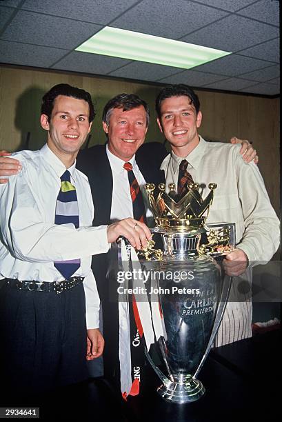 Ryan Giggs, Sir Alex Ferguson and Lee Sharpe of Manchester United celebrate in the dressing room with the Premiership Trophy after becoming FA...