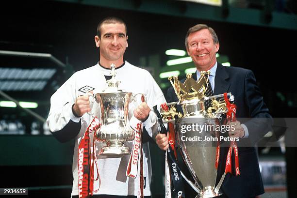 Eric Cantona and manager Sir Alex Ferguson of Manchester United with the FA Cup and Premiership Trophy at Victoria Station, Manchester on May 12,...