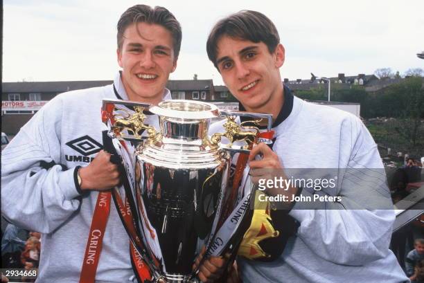 David Beckham and Gary Neville of Manchester United celebrate with the Premiership Trophy during the celebration parade May 12, 1996