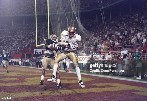 Wide receiver Andre Cooper of the Florida State Seminoles catches the ball and is tackled by a Notre Dame Fighting Irish player during a game at the...