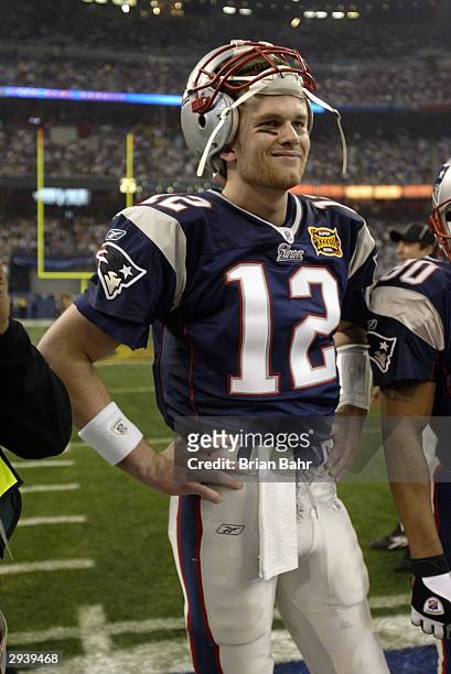 Quarterback Tom Brady of the New England Patriots stands on the field before Super Bowl XXXVIII against the Carolina Panthers at Reliant Stadium on...