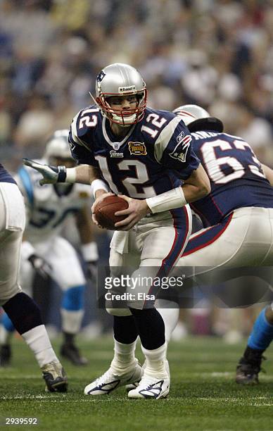 Qaurterback Tom Brady of the New England Patriots attempts a hand off against the Carolina Panthers during Super Bowl XXXVIII at Reliant Stadium on...