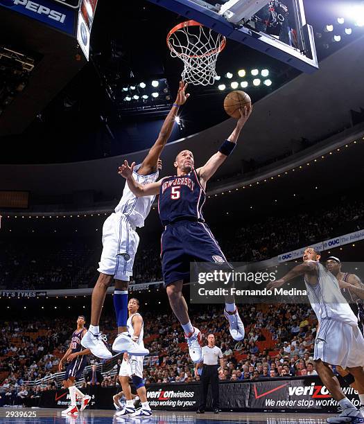 Jason Kidd of the New Jersey Nets shoots against Tracy McGrady of the Orlando Magic during the game at the TD Waterhouse Center on January 29, 2004...