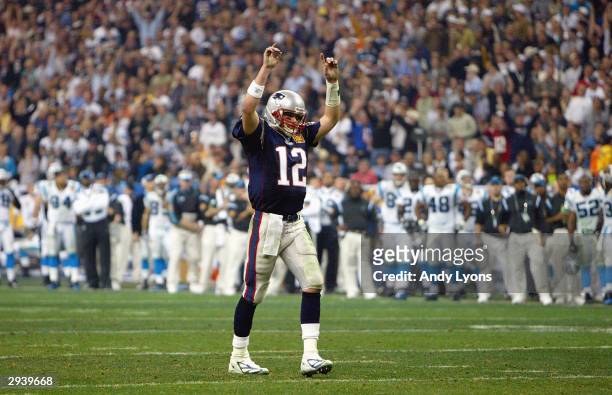 Quarterback Tom Brady of the New England Patriots raises his arms in celebration of a play against the Carolina Panthers during Super Bowl XXXVIII at...
