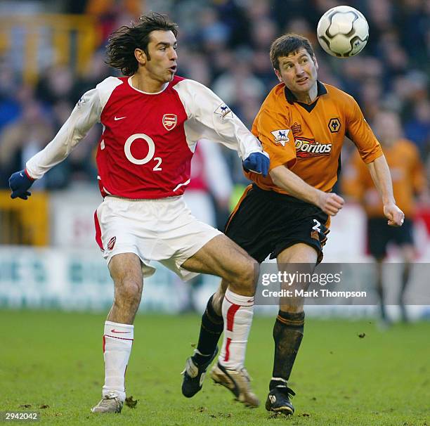 Denis Irwin of Wolves controls the ball as Robert Pires of Arsenal looks on during the FA Barclaycard Premiership match between Wolverhampton...