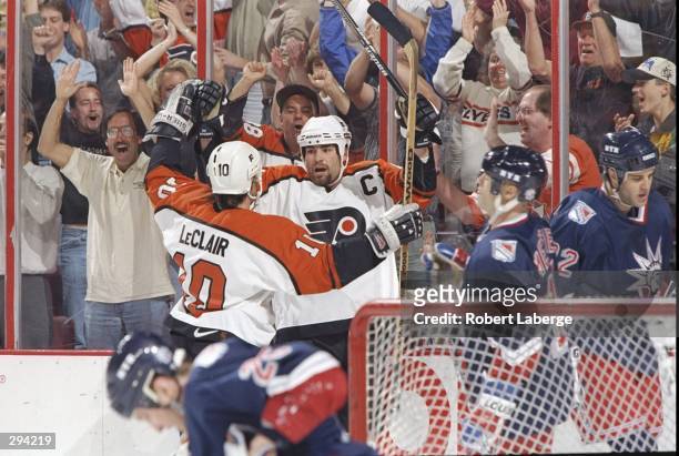 Eric Lindros of the Philadelphia Flyers celebrates with teammate John LeClair after they defeated the New York Rangers 4-2 during the Eastern...