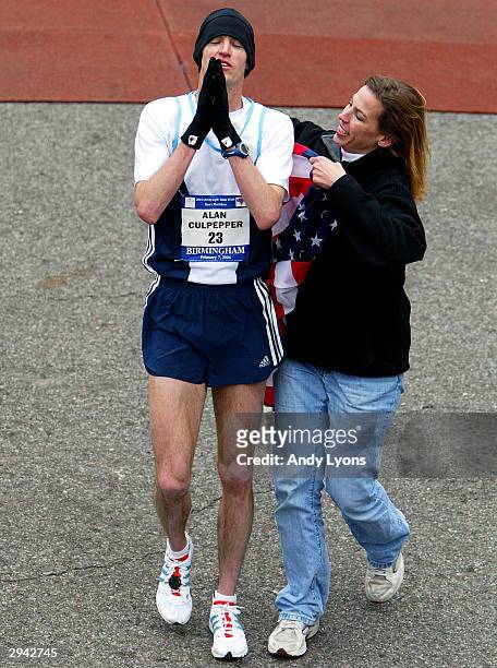 Alan Culpepper of Lafayette, Colorado reacts to winning the U.S. Olympic Marathon Trials as he has an American flag around him by race director...