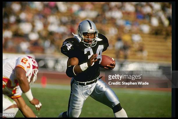 Running back Bo Jackson of the Los Angeles Raiders runs down the field during a game against the Kansas City Chiefs at the Los Angeles Coliseum in...