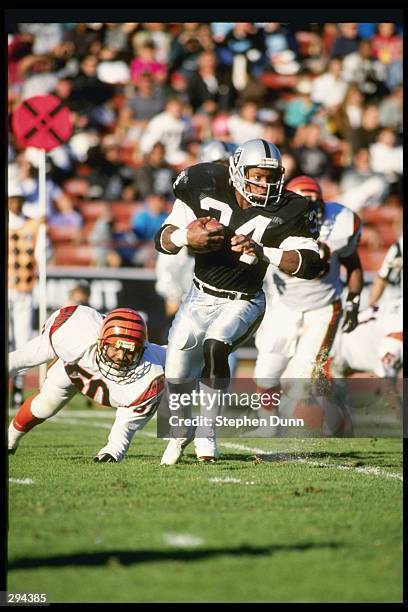 Running back Bo Jackson of the Los Angeles Raiders runs down the field during a game against the Cincinnati Bengals at the Los Angeles Coliseum in...