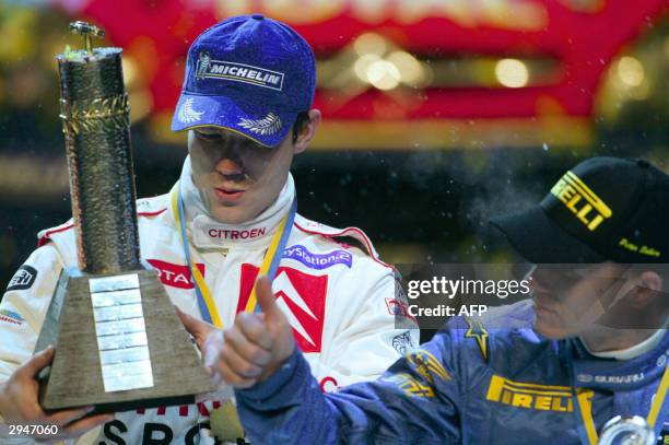 Sebastien Loeb of France inspects the trophy on which his name will be engraved after winning the Uddeholm Swedish Rally, 08 February 2004. Loeb is...