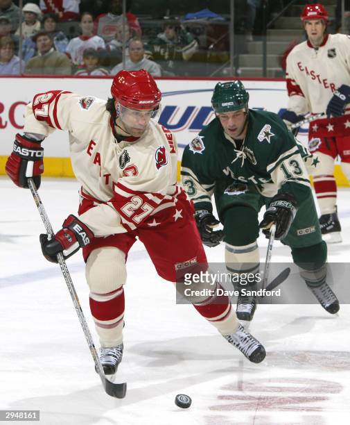 Eastern Conference All Star Scott Niedermayer of the New Jersey Devils is challenged by Western Conference All Star Bill Guerin of the Dallas Stars...
