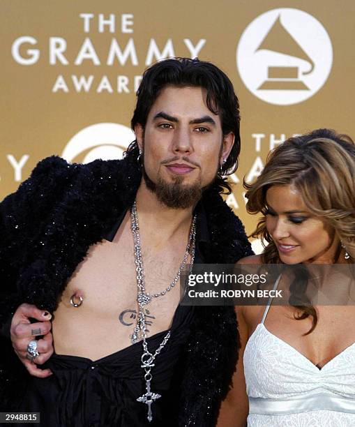 Musician Dave Navarro exposes his chest adorned with nipple ring beside girlfriend Carmen Electra upon their arrival for the 46th Annual Annual...