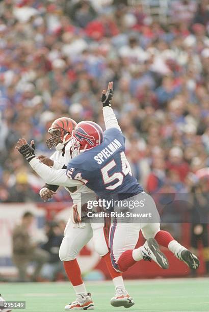Quarterback Jeff Blake of the Cincinnati Bengals is sacked by linebacker Chris Spielman of the Buffalo Bills during the Bengals 31-17 loss to the...