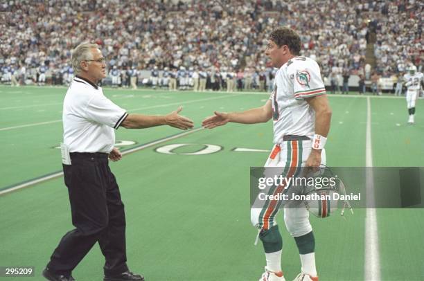 Quarterback Dan Marino shakes hands with coach Don Shula of the Miami Dolphins during a game against the Indianapolis Colts at the RCA Dome in...