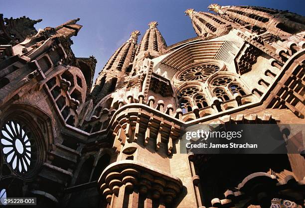 spain,barcelona,low angle view of sagrada familia by gaudi - sagrada familia stockfoto's en -beelden