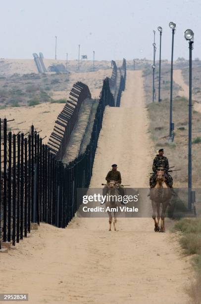 Indian Border Security Force constables on camel back patrol the border with Pakistan February 8, 2004 in Tanot, India. The 470-kilometre desert...