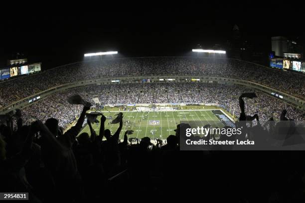 Fans celebrate during start of the NFC Wildcard game between the Dallas Cowboys and the Carolina Panthers at Ericsson Stadium on January 3, 2004 in...