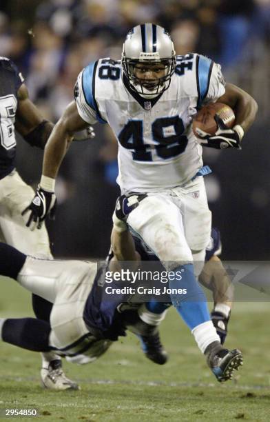 Running back Stephen Davis of the Carolina Panthers attempts to run through the tackle of a Dallas Cowboys defender during the NFC Wildcard playoff...