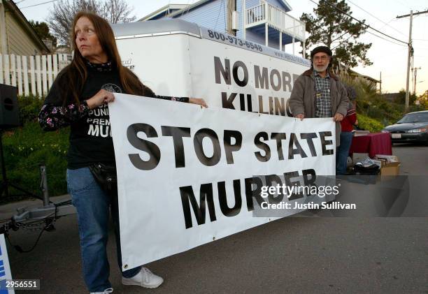 Melanie Bostic of Lancaster, California and Michael Wharton of San Leandro, California hold a sign outside of the California State Prison at San...