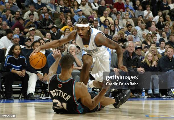 Carmelo Anthony of the Denver Nuggets dekes out Shane Battier of the Memphis Grizzlies in the second half February 9, 2004 at the Pepsi Center in...