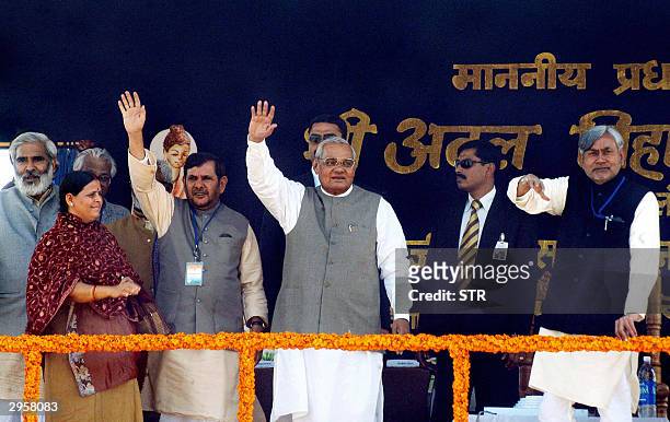 Indian Prime minister Atal Bihari Vajpeyen , Railway Minister Nitish Kumar and Minister Food and Supply Sharad Yadav wave to the crowd as Bihar Chief...