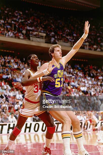 Mark Eaton of the Utah Jazz battles for post position against Hakeem Olajuwon of the Houston Rockets during an NBA game at The Summit circa 1987 in...