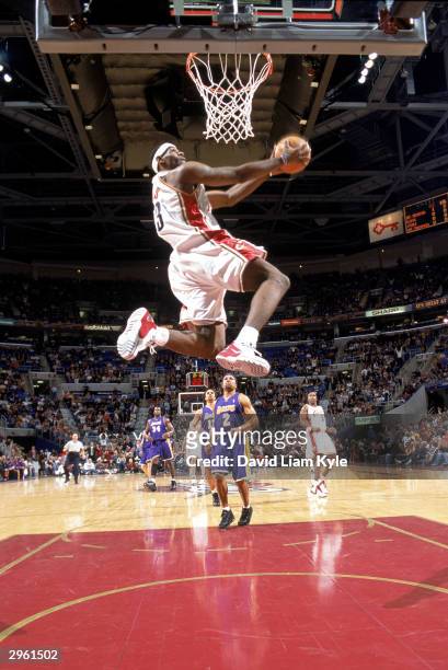 LeBron James of the Cleveland Cavaliers goes up for a reverse dunk during the game against the Los Angeles Lakers at Gund Arena on February 4, 2004...